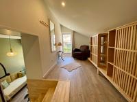 a living room with a staircase with a couch and a chair at Le LOUIS 16 - Maison avec jardin in Valence