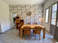 a dining room with a wooden table and chairs at Le LOUIS 16 - Maison avec jardin in Valence