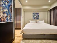 Postel nebo postele na pokoji v ubytování Floral Court Hotel & Residence Sukhumvit 13