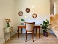 a desk with a chair and plates on the wall at Le LOUIS 16 - Maison avec jardin in Valence
