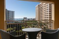 a patio with a table and chairs on a balcony at The Ritz-Carlton, Sarasota in Sarasota