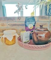 a tray with a tea pot and other items on a table at Un cocon face à la mer in Plérin