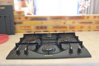 a stove top oven sitting next to a brick wall at Un cocon face à la mer in Plérin