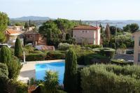 a view of a yard with trees and a swimming pool at Les jardins de Bandol, piscine et mer in Bandol