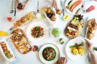 a table with plates of food on it at JW Marriott Marquis City Center Doha in Doha