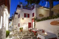 a restaurant with tables and chairs in a street at night at 23 Hotel Mykonos in Mýkonos City