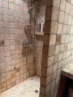 a bathroom with a shower in a stone wall at Appartement cosy, esprit chalet avec jolie vue in Saint-Gervais-les-Bains