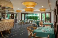 a restaurant with blue tables and chairs and windows at Sunshine Resort Intime Sanya in Sanya