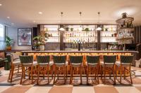 a bar in a restaurant with stools at Brussels Marriott Hotel Grand Place in Brussels