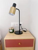 a desk with a lamp on top of a dresser at Chez les deux garçons in Montrouge
