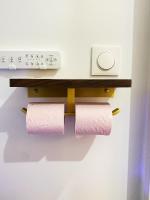 a towel rack with two rolls of toilet paper on a wall at Chez les deux garçons in Montrouge
