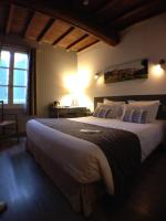 a bedroom with a large bed in a room at Logis Hotel Restaurant la Ferme in Avignon