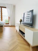 a living room with a flat screen tv on a dresser at Chez les deux garçons in Montrouge