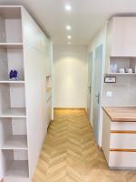 a hallway with white cabinets and a wooden floor at Chez les deux garçons in Montrouge