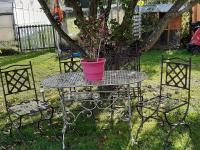 a table with a potted plant on it with two chairs at LA TOULOTTE chez Claire et Christian in Sancy-lès-Provins