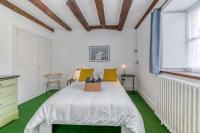 a bedroom with a large white bed with yellow pillows at Le Charme Antique¶ Belle maison¶ Centre Gières in Gières