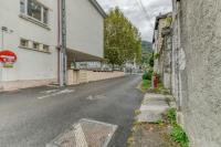 an empty street with a building and a red fire hydrant at Le Charme Antique¶ Belle maison¶ Centre Gières in Gières