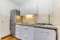 a kitchen with white cabinets and a sink and a refrigerator at Le Charme Antique¶ Belle maison¶ Centre Gières in Gières