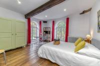 a bedroom with a large bed and red curtains at Le Charme Antique¶ Belle maison¶ Centre Gières in Gières