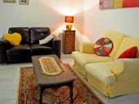 a living room with a couch and a table at Gencay La maison blanche in Gençay