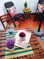 a table with a newspaper and a bowl of fruit at San Juan Apartamento in Jerez de la Frontera