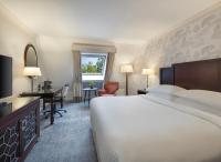 ein Hotelzimmer mit einem großen Bett und einem Schreibtisch in der Unterkunft Delta Hotels by Marriott Worsley Park Country Club in Worsley