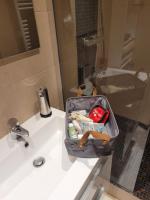 a bathroom sink with a suitcase on top of it at L&#39;appartement Idéal 4 voyageurs in Boulogne-Billancourt