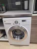 a white washing machine sitting in a kitchen at L&#39;appartement Idéal 4 voyageurs in Boulogne-Billancourt