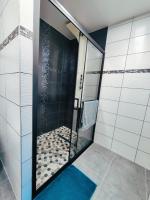 a bathroom with a shower with a blue rug at Vigny du lac in Publier