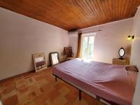 a bedroom with a large bed with a wooden ceiling at Le Bohème in Sigean