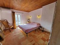 a bedroom with a bed and a wooden ceiling at Le Bohème in Sigean