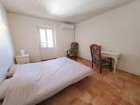 a bedroom with a bed and a table and chairs at Le Bohème in Sigean