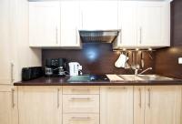 a kitchen with white cabinets and a sink at GRAY 2a6 in Cannes