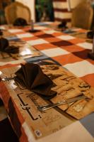 a table with a cowboy hat on a checkered table cloth at Tuya Hotel in Abu Simbel