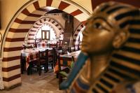 a statue in a restaurant with tables and chairs at Tuya Hotel in Abu Simbel