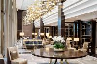 a lobby of a hotel with a table and chairs at Hilton Budapest in Budapest