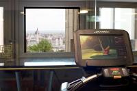 a tv on a stand in front of a window at Hilton Budapest in Budapest