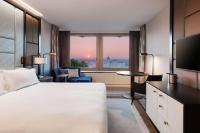 a hotel room with a bed and a large window at Hilton Budapest in Budapest