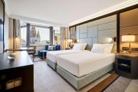 a hotel room with a large bed and a desk at Hilton Budapest in Budapest