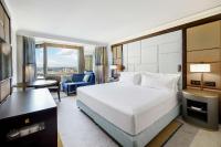 a hotel room with a bed and a desk and a room at Hilton Budapest in Budapest