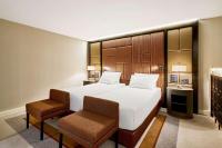 a hotel room with a large bed and two chairs at Hilton Budapest in Budapest