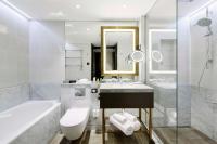 a bathroom with a tub and a sink and a toilet at Hilton Budapest in Budapest