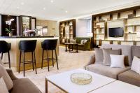 a living room with a couch and a bar at Hilton Budapest in Budapest