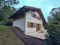 a small white house with a wooden roof at Gîte Anould, 4 pièces, 6 personnes - FR-1-589-2 in Anould