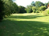 a lush green yard with trees and a large field of grass at Gîte Anould, 4 pièces, 6 personnes - FR-1-589-2 in Anould