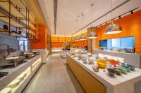 a large kitchen with a long counter with bowls on it at Rezen Select Hotel Guagnzhou Baiyun International Airport T2 in Huadu