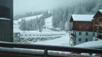 a view of a snow covered mountain from a window at Appart 4-6 pers au pied des pistes toutes saisons in Molines-en-Queyras