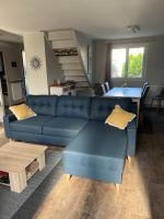 a living room with a blue couch and a table at Maison du Lavoir Disneyland in Bailly-Romainvilliers