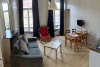 a living room with a couch and a table at VIEUX LILLE Porte de Gand Bienvenue chez NESTYOU, Lille in Lille