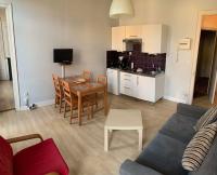 a living room with a couch and a table and a kitchen at VIEUX LILLE Porte de Gand Bienvenue chez NESTYOU, Lille in Lille